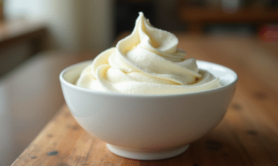 Crème fouettée fraîche dans un bol sur une table en bois rustique